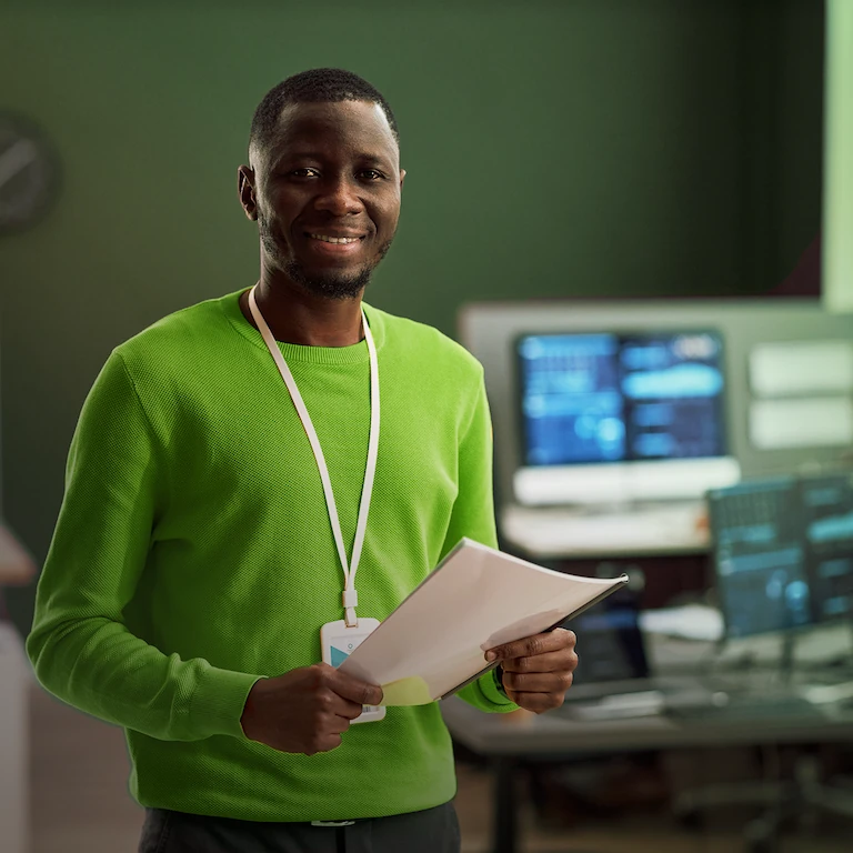 Person smiling with some documents in their hand