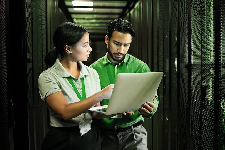 Two people looking at a laptop