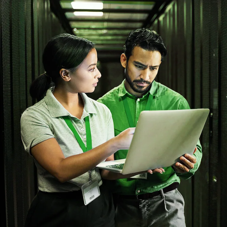 Two people looking at a laptop discussing