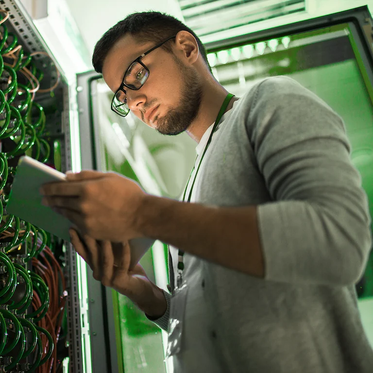 person looking at a tablet in a data centre