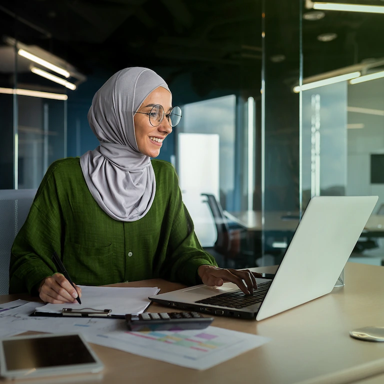 Person sitting looking at a laptop