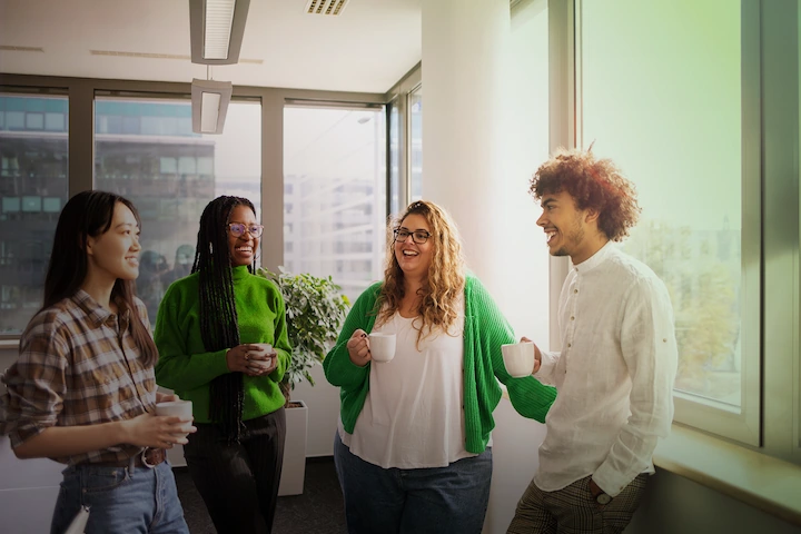 Four people standing and talking