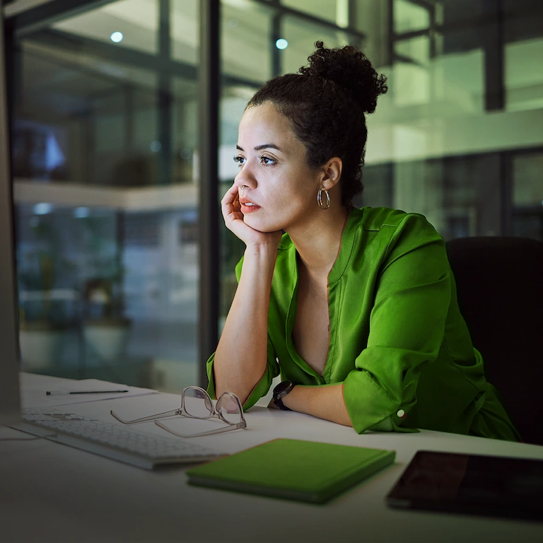 Person looking at a computer screen deep in thought